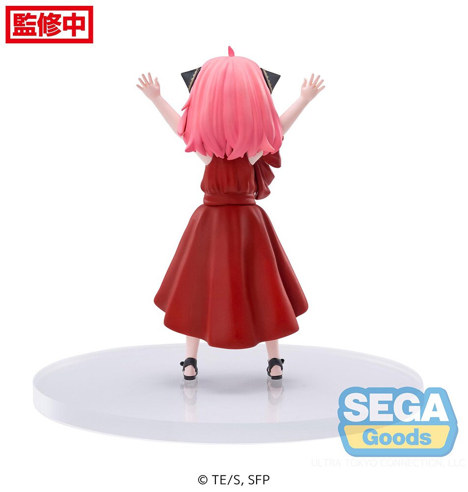rear-view showcasing Anya's red dress and raised arms.