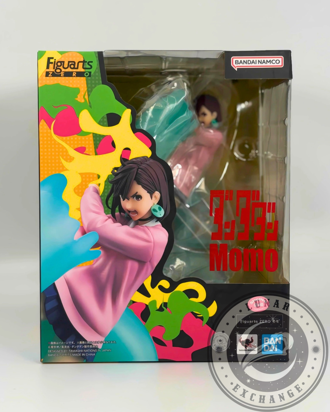 Front of retail box showing Momo Ayase figure through the window, colorful background artwork, and product branding.