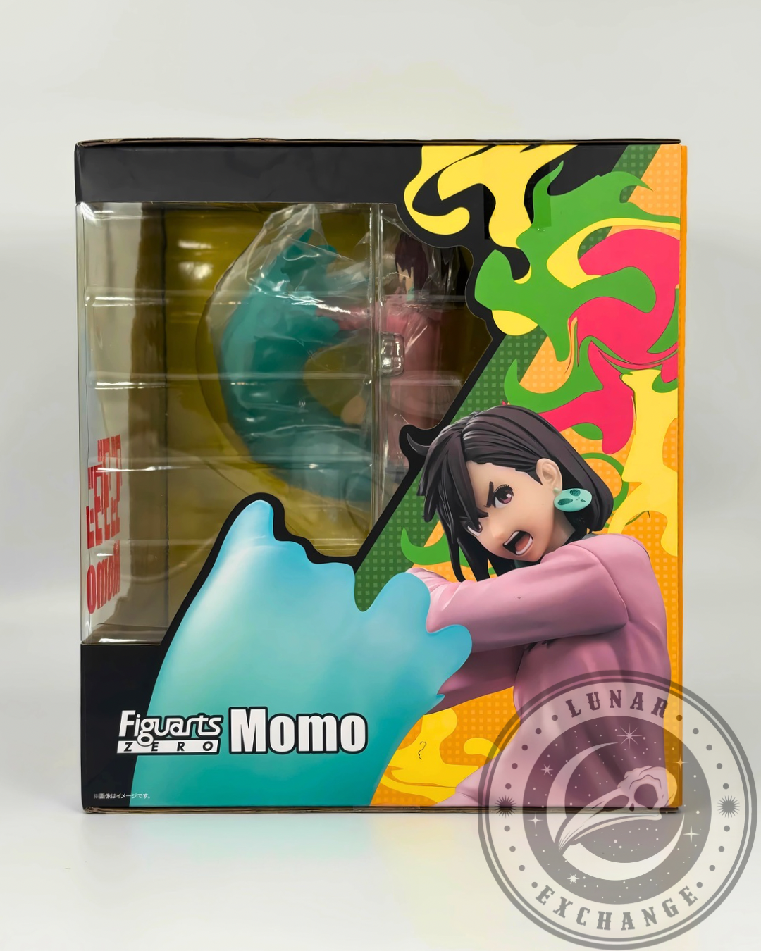Side window view of the Momo Ayase figure inside packaging with bold graphic design and character pose.