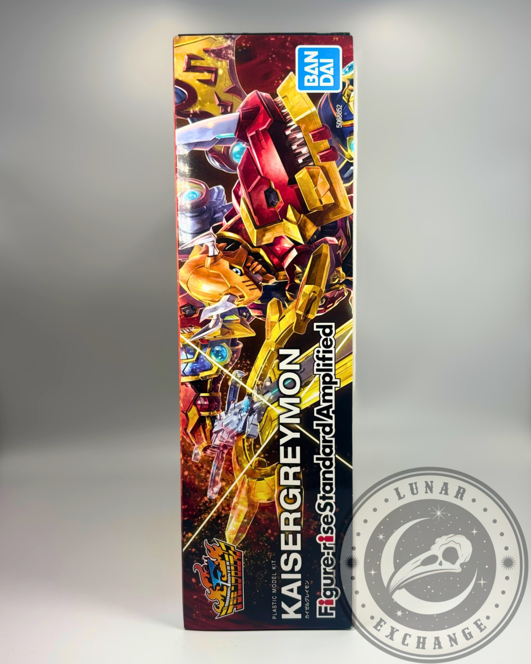 Left side panel of the KaiserGreymon model kit box displaying close-up key art of the Digimon character and product branding.