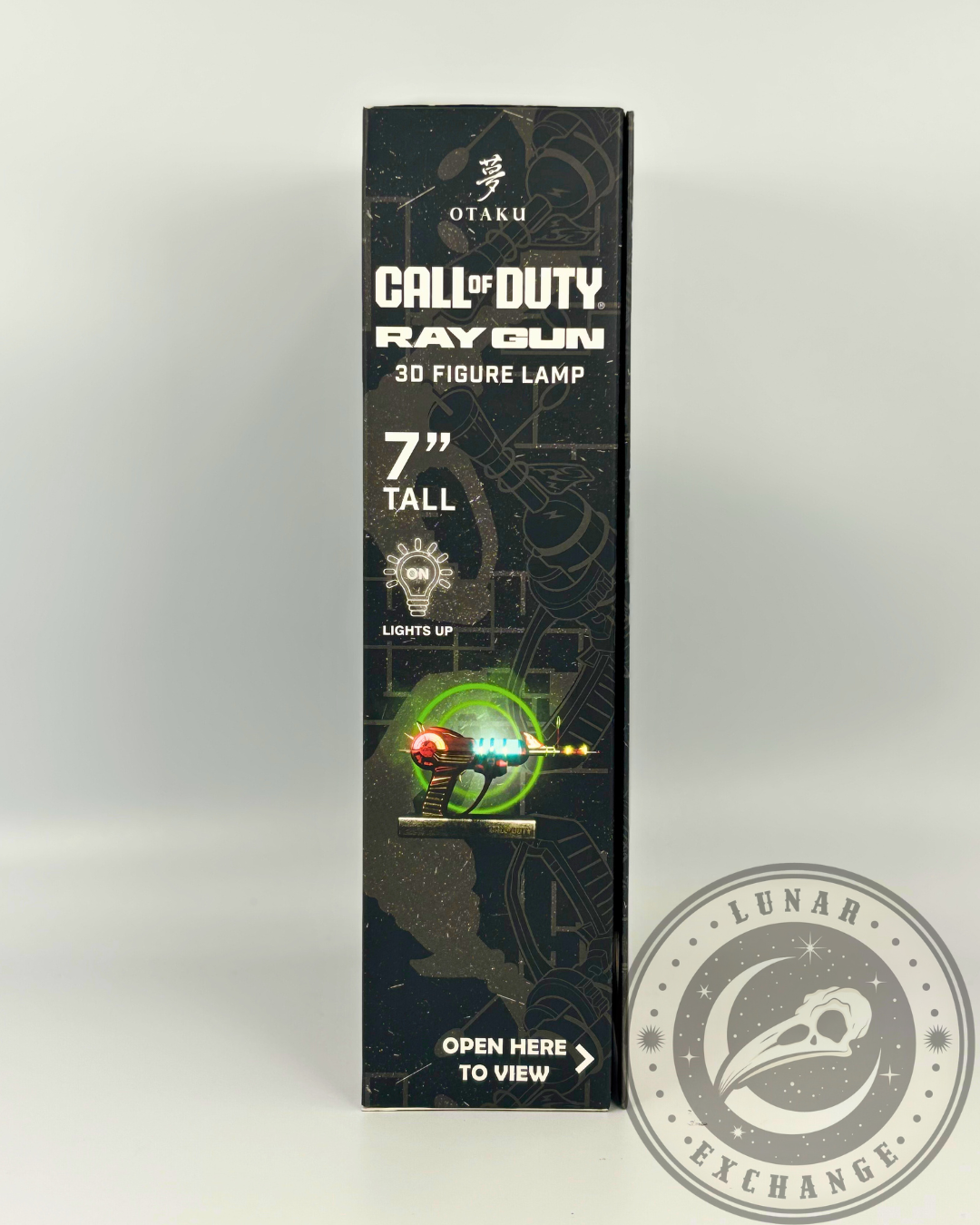 Side panel of the Call of Duty Ray Gun box showing product dimensions, “Lights Up” feature icon, and interactive "Open Here to View" label.