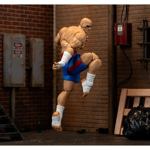 Rear view of Sagat action figure mid-jump performing a knee strike.