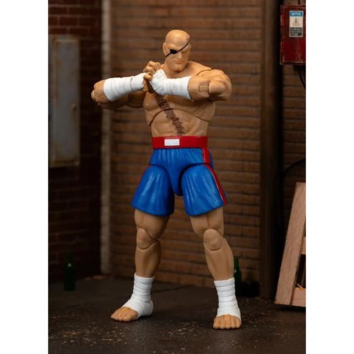 Sagat action figure posed ready for battle with arms crossed.