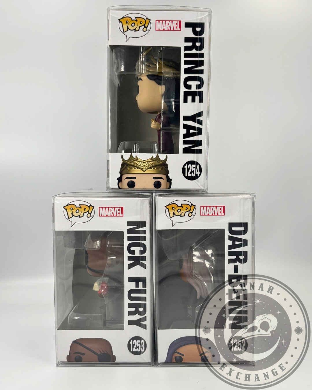 Side view of boxed Funko Pop! figures from The Marvels lineup showing vertical names: Prince Yan, Nick Fury, and Dar-Benn in stack formation.