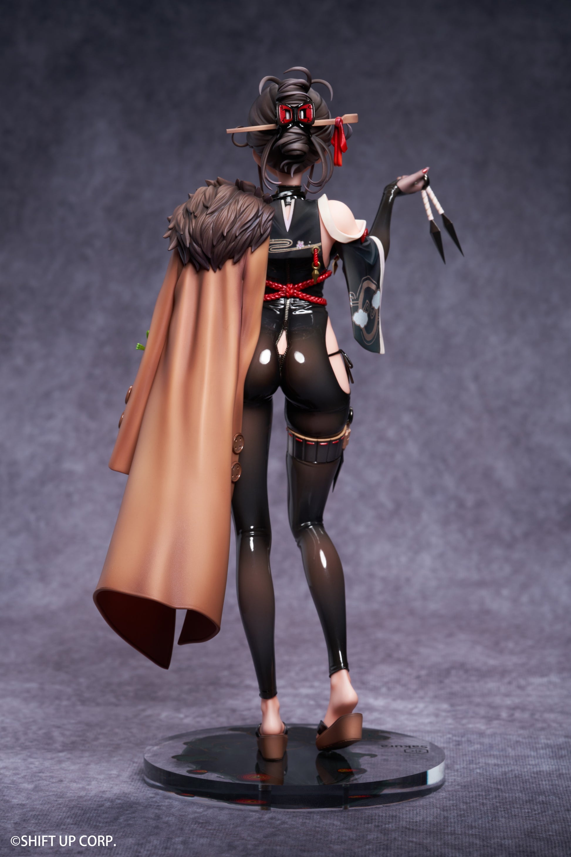 Rear view displaying the figure’s sculpted features and flowing attire.