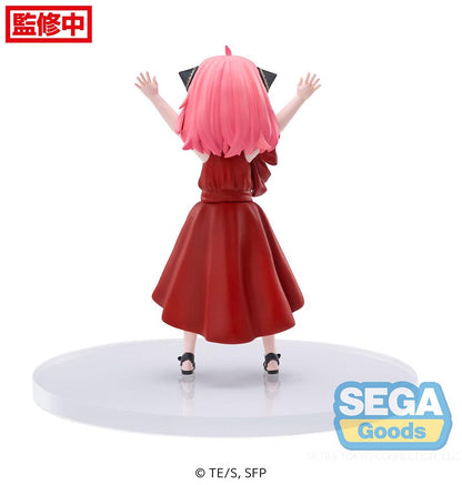 rear-view   showcasing Anya's red dress and raised arms.