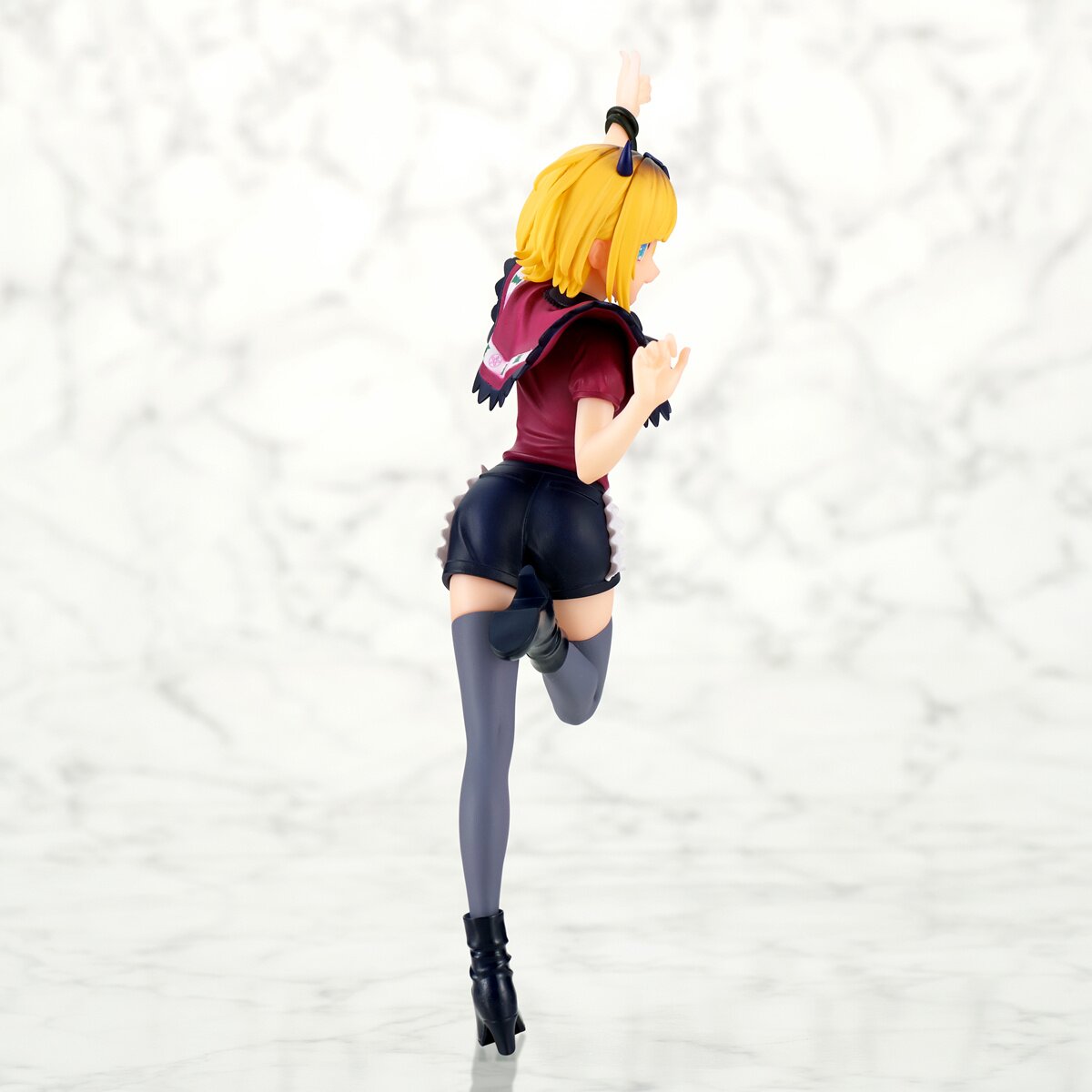Rear view displaying the figure's sculpted hair and clothing folds.
