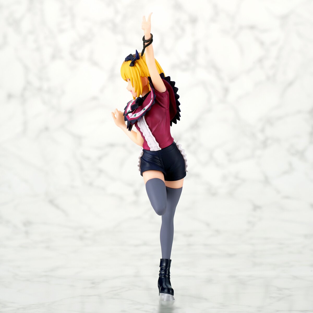 Side profile showcasing Mem-Cho's dynamic pose and outfit details.