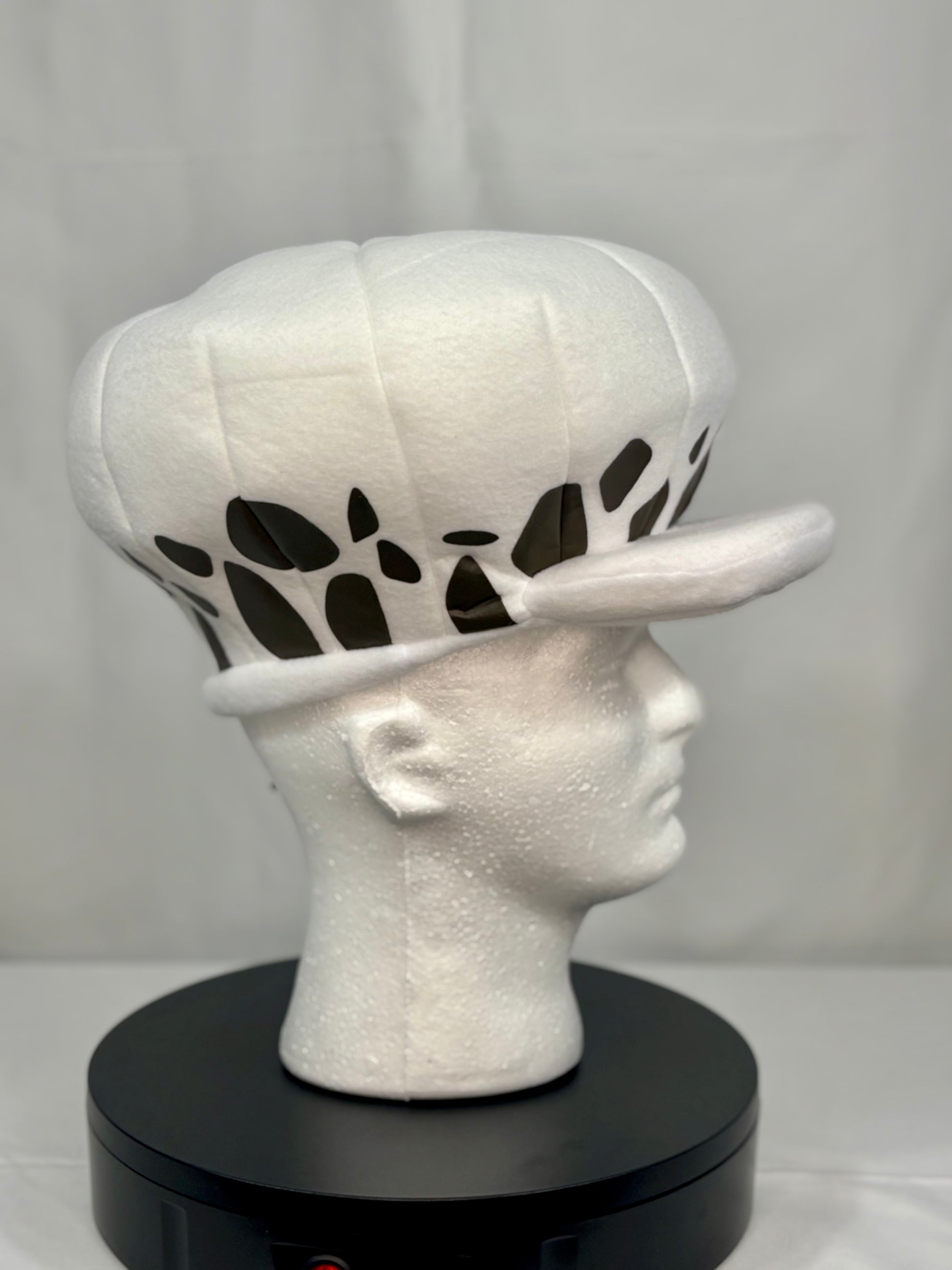 Side angle showing cow-print brim detail