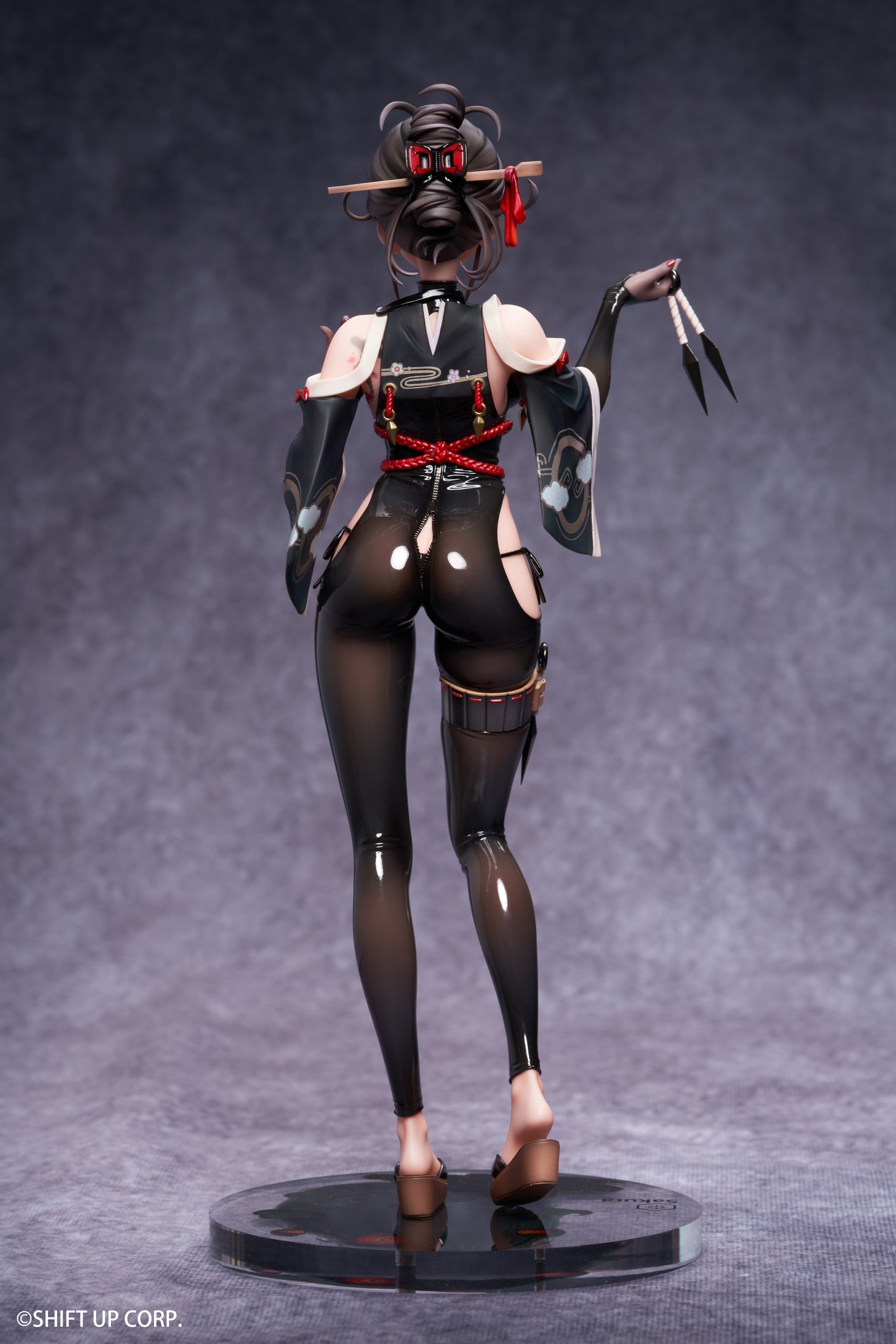 Rear view displaying the figure’s sculpted features and flowing attire.