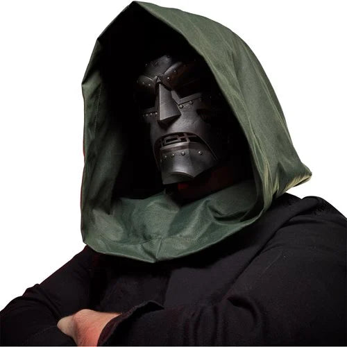 Person wearing the Doctor Doom helmet with green hood and arms crossed in dramatic cosplay pose.