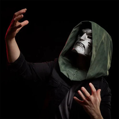 Cosplayer wearing the Doctor Doom helmet reaching forward with theatrical expression.