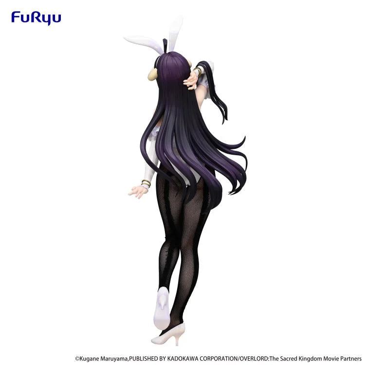 Rear view displaying the figure’s sculpted features and stand.