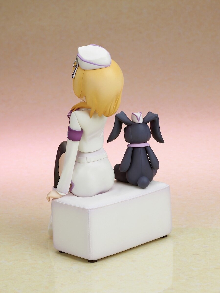 Rear view displaying the figure’s sculpted features and stand.