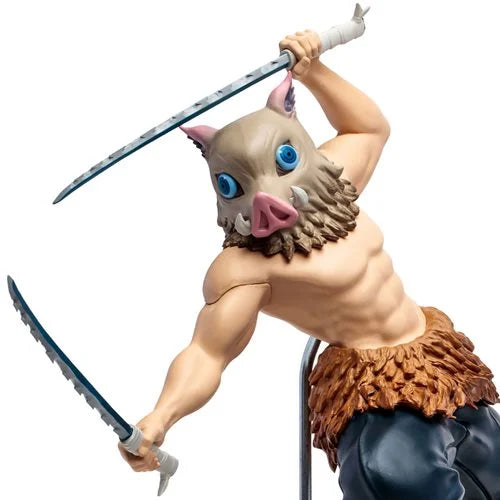 Close-up of Inosuke Hashibira statue highlighting sculpted boar mask, dual swords, and muscle details.