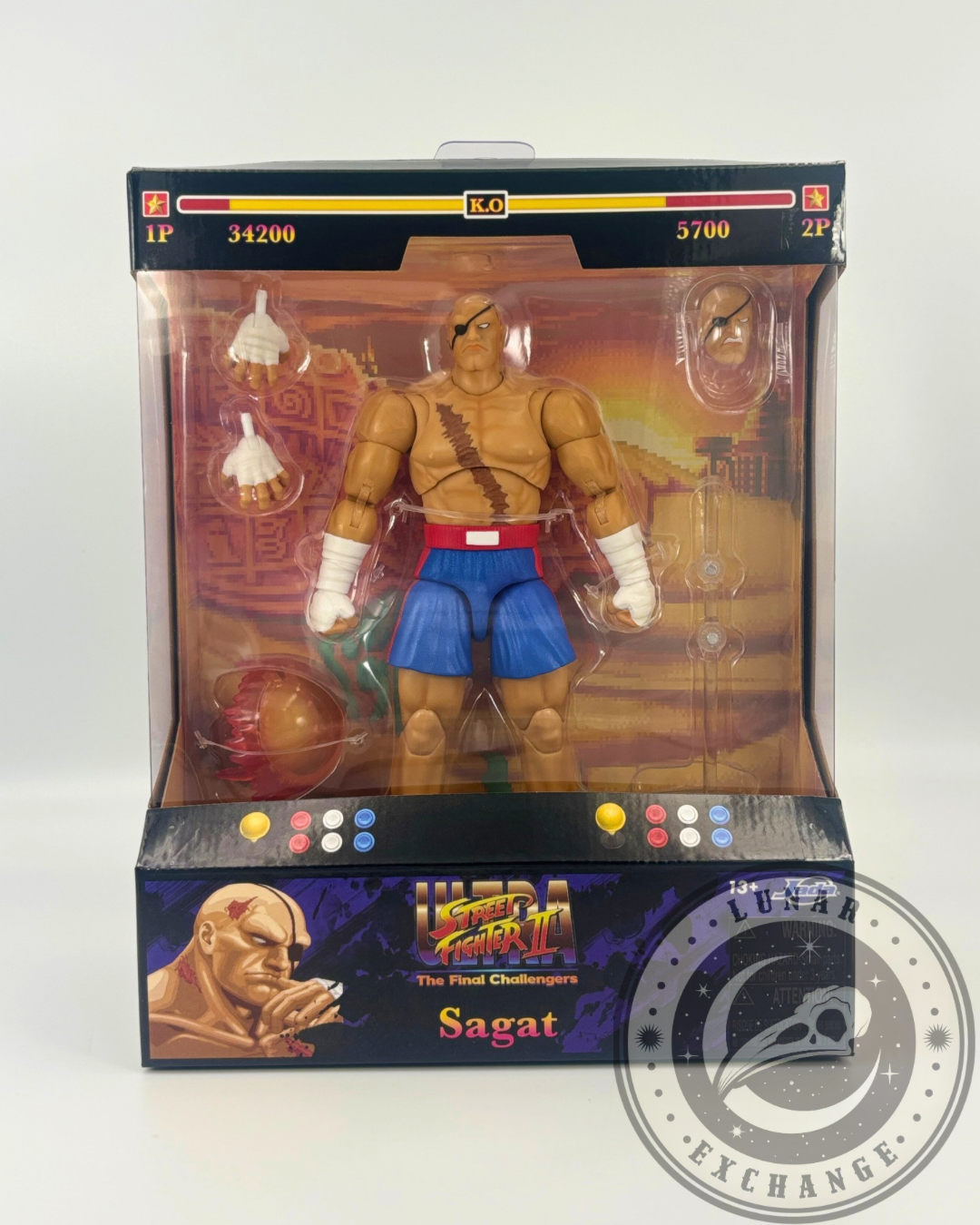 Jada Toys Sagat figure from Ultra Street Fighter II displayed in arcade-themed packaging with extra parts and accessories.