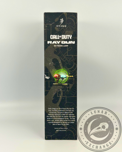 Side of the box featuring a detailed product description by Otaku, highlighting the Ray Gun's glow, nostalgic appeal, and decorative use.