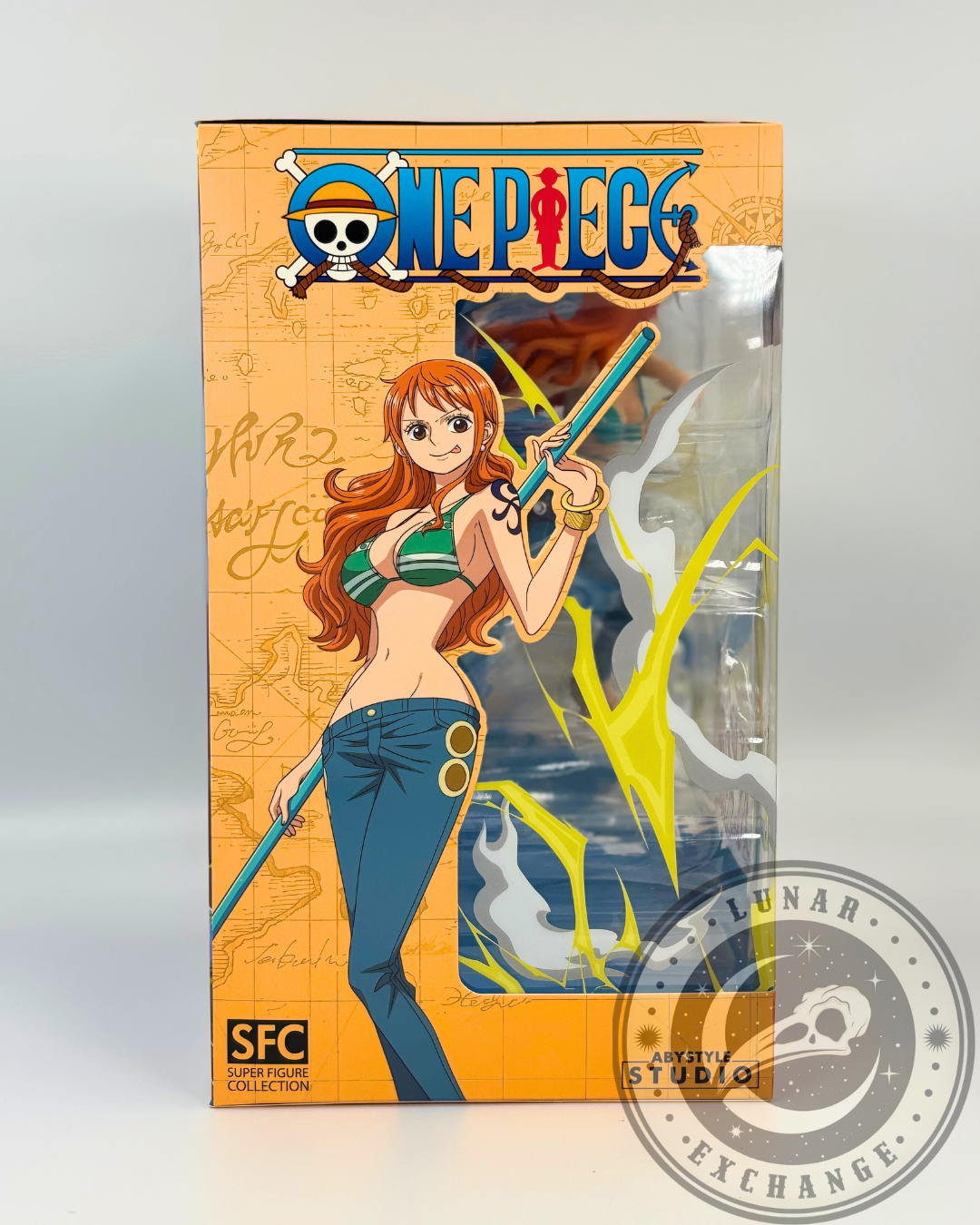 Side of the packaging with anime artwork of Nami holding her staff, styled against an orange map-themed background with One Piece logo.