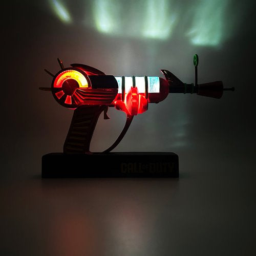 Dark environment shot of the Ray Gun lamp illuminated with glowing red and blue sections, simulating in-game lighting effects.