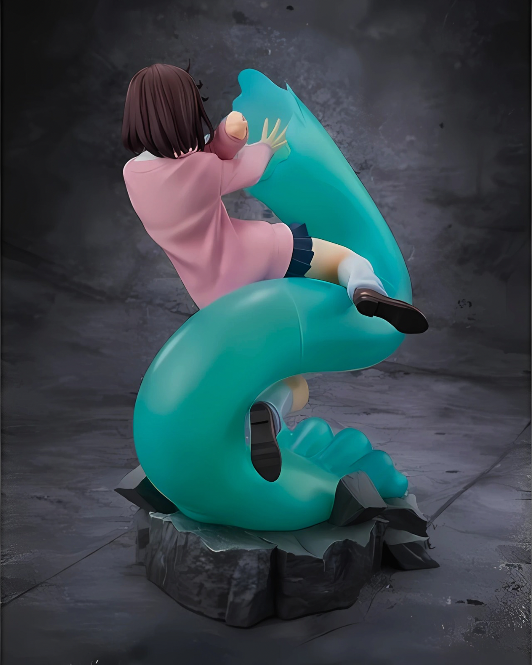Rear view of the Dandadan Momo statue showing the curling specter arm and base rubble.