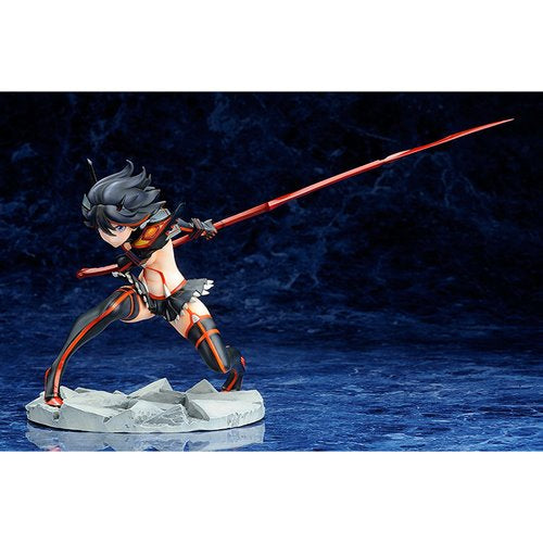 Side view of the Ryuko Matoi figure displayed on a rocky base with her red scissor blade extended forward.