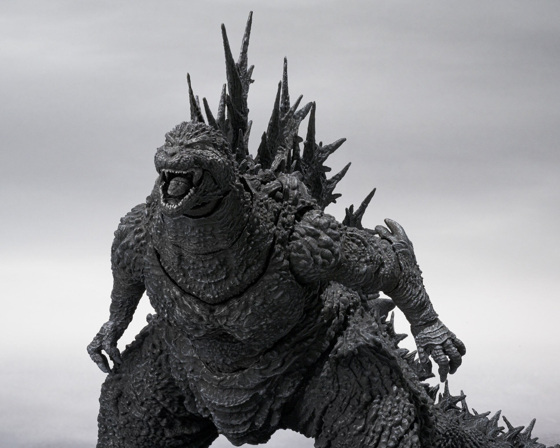 High-angled dramatic view of Godzilla Minus One 2023 with open mouth, highlighting chest and arms mid-pose.