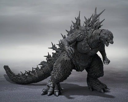 Angled view of Godzilla Minus One figure displaying back spikes and detailed tail sculpt, left-side perspective.