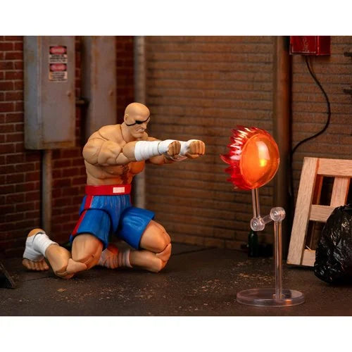 Sagat figure kneeling and firing energy projectile using Tiger Shot effect.