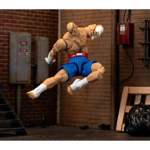 Sagat action figure in mid-air side kick with dynamic pose in alleyway.