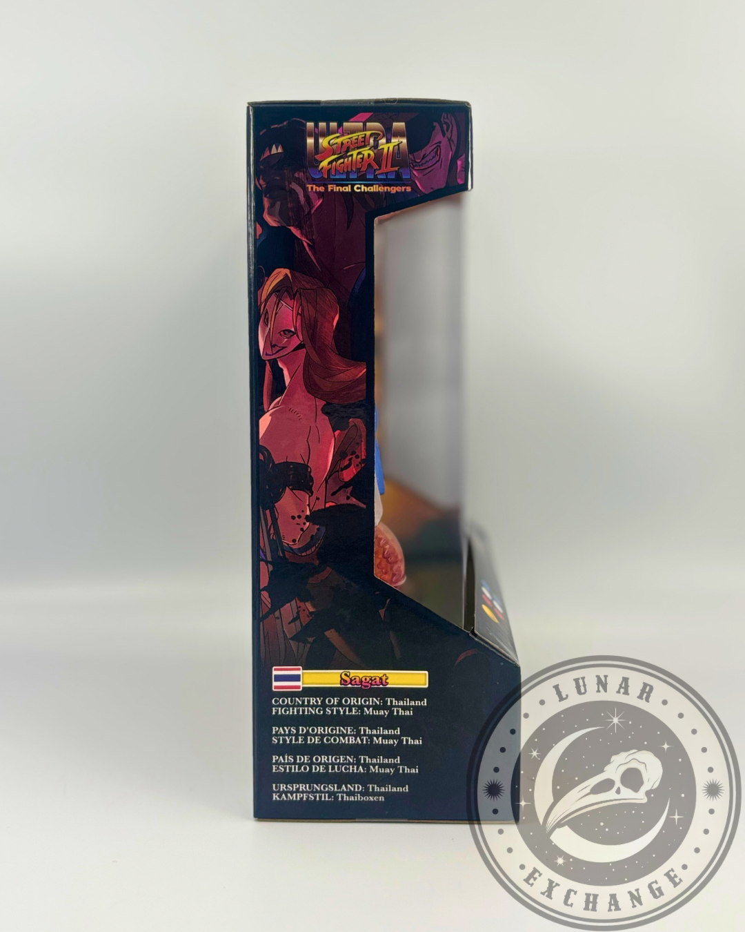 Side view of Sagat’s packaging listing country of origin as Thailand and fighting style as Muay Thai, with stylized artwork.