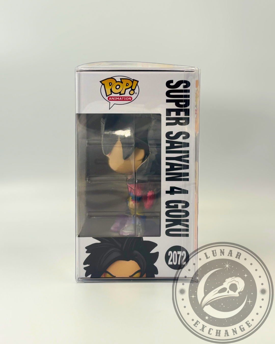 Left side profile of the Funko Pop! Super Saiyan 4 Goku #2072 showing the character name and side window view of the figure inside the box protector.