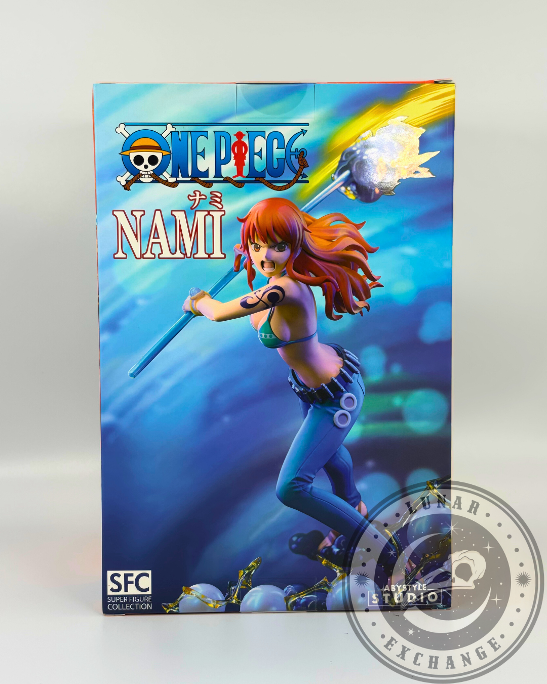 Back of the Nami figure box showing the full illustrated action pose of the figure with a blue background and glowing effects.